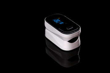 Pulse oximeter / peripheral capillary oxygen saturation meter (SPO2) for assessing the amount of oxygen in the blood on a black background with correct measurement indicators