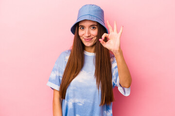 Young caucasian woman isolated on pink background cheerful and confident showing ok gesture.