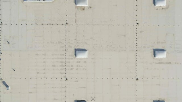 Big drone flying over a roof to inspect and measure it