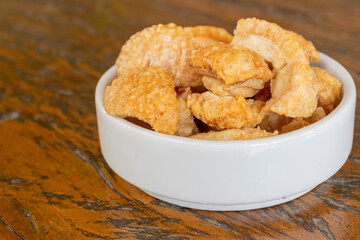 fried cracklings in a white bowl. typical dish of brazilian cuisine