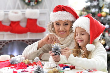 Portrait of grandmother and child preparing for Christmas