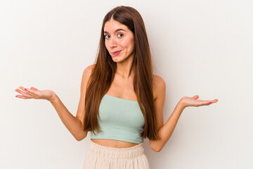 Young caucasian woman isolated on white background doubting and shrugging shoulders in questioning...