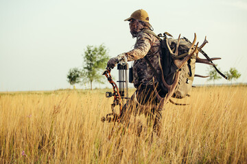 Bow hunter tracking prey. Modern Bow Hunter.
