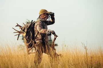 Foto op Plexiglas Archery hunter scouting for his next target. © zorandim75