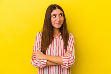 Fototapeta premium Young caucasian woman isolated on yellow background dreaming of achieving goals and purposes