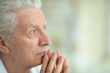 Close up portrait of sad thinking senior man