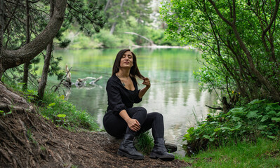 woman sitting in the forest next to the lake France