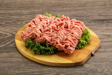 Raw pork minced meat over board