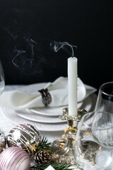Christmas table setting with white napkins, antique sliver cutlery and candleholders