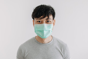 Close up of Happy Asian man wears mask isolated on white background.