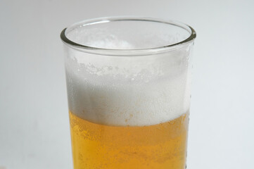 Mug of beer with foam on white background.close up