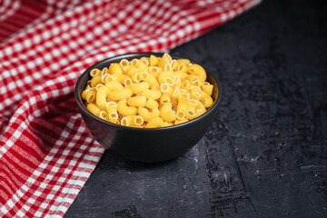 Different kind of raw pasta in bowls