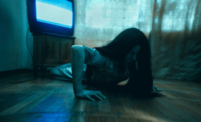 Girl in image of scary zombie crawls on floor in dark room.