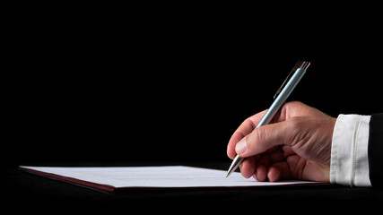 Hand of a businessman signing a document or contract