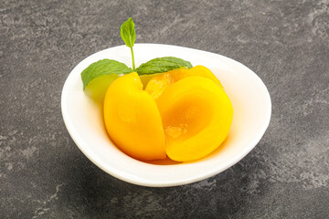 Sweet ripe canned peaches with mint