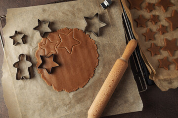 Christmas gingerbread dough in the cooking process. on a dark background
