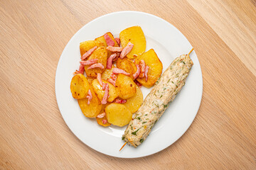 chicken kebab with fried potatoes