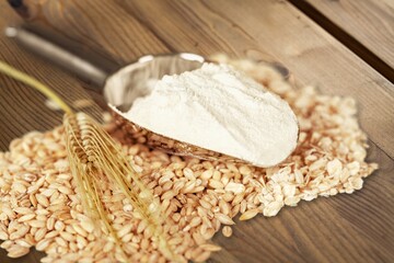 Wheat ears and flour on a kitchen desk