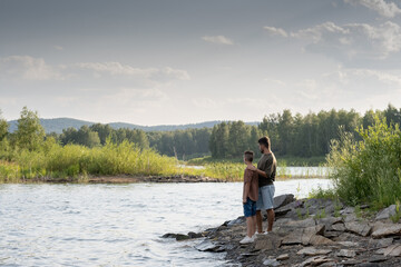 Idyl of serene father and son enjoying summer weekend in the country