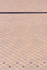 Background of the flat roof of the building with rows of brown tiles