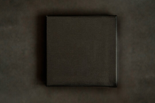 Black square clean canvas for photography or drawing lies on black background (971)