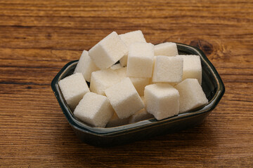 Refined white sugar cubs in the bowl