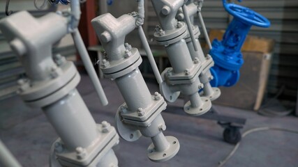 Painting of pipeline fittings. Steam pipe with a valve.