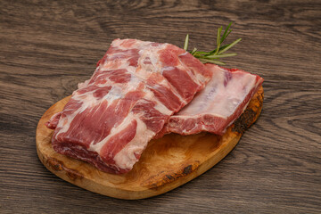 Raw pork ribs served rosemary