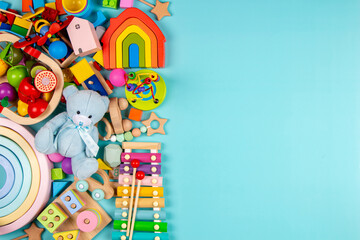 Baby kids toys on light blue background. Colorful educational wooden and musical toys. Top view, flat lay