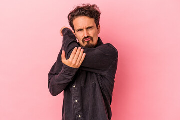 Young caucasian man isolated on pink background having a neck pain due to stress, massaging and touching it with hand.