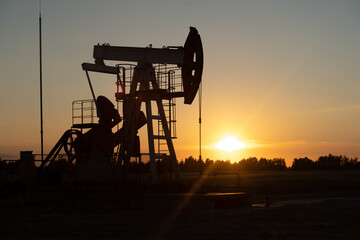 Oil Pump on orange sunset.