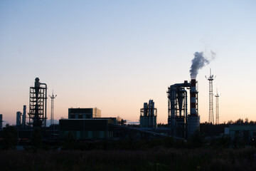 Fototapeta premium Factory pipe polluting air against sunset, environmental problems, smoke from chimneys.
