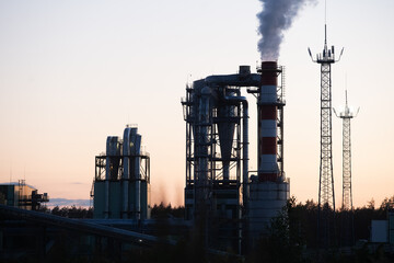Fototapeta na wymiar Factory pipe polluting air against sunset, environmental problems, smoke from chimneys.