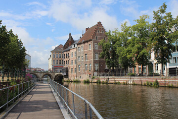 Fototapeta na wymiar View of the River Dijl and and surrounding historic buildings near 'Grootbrug' in Mechelen, Antwerp province, Belgium.