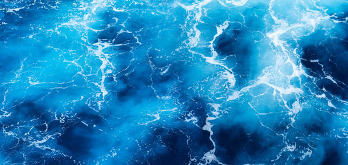 Waves and blue water as a background. View at the ocean surface. Natural summer seascape. Water...