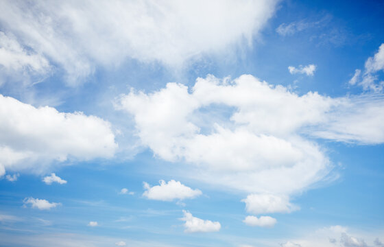 Captivating blue sky with white fluffy clouds in sunny day.