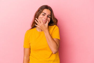 Young caucasian woman isolated on pink background  doubting between two options.