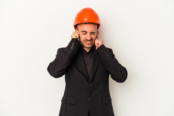 covering ears with hands.