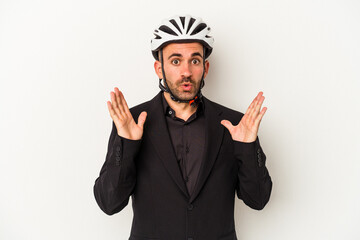 Young business bald man wearing a bike helmet isolated on white background  surprised and shocked.