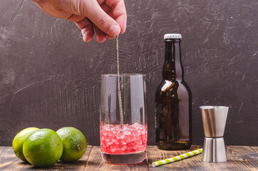 Stirring the drink with ice in a glass
