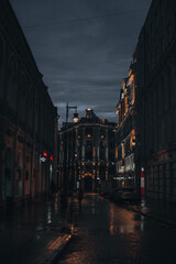 Obraz na płótnie Canvas Dark evening street after rain with vintage houses in the city center