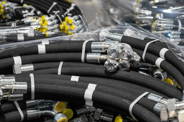 Bundle of new high pressure hydraulic hoses in a package. Hydraulic hoses with yellow plugs.