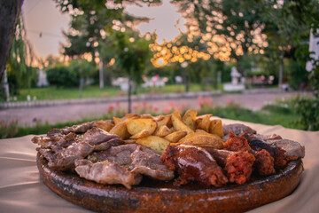 Grilled meat in a garden during a sunset