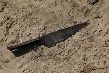 Medieval rusty knife on the sand