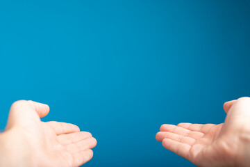 male  shows outstretched hand with open palm