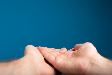 male  shows outstretched hand with open palm