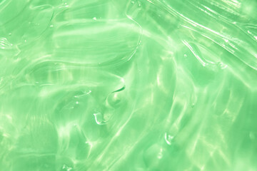Green water Aloe Vera gel smudged texture. Abstract clear cosmetic cream, face serum, moisturizer background