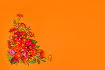 Corner composition made of marigold flowers on orange background. Day of the dead, Dia De Los Muertos, halloween, thanksgiving day celebration festival flyer. Copy Space. Flat lay, top view
