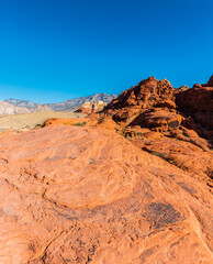 Fototapeta na wymiar The Aztec Sandstone of the Calico Hills With Turtlehead Peak In The Distance, Red Rock Canyon NCA, Las Vegas, USA