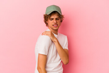Fototapeta premium Young caucasian man with make up isolated on pink background having a shoulder pain.